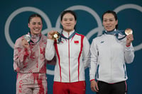 | Photo: AP/Kin Cheung : Medalist, Maude Charron of Canada, silver, Luo Shifang of China, gold, and Kuo Hsing-Chun of Taiwan, bronze, celebrate during the medal ceremony for the women's 59kg weightlifting event